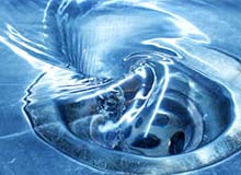 Photograph of water draining in a whirlpool down a kitchen sink drain.