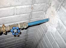 Photograph of polybutylene water supply line entering through foundation